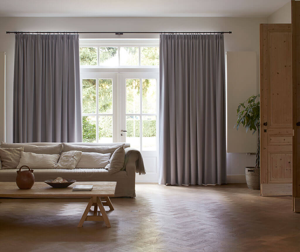 Grau-blaue Gardine mit doppelter Falte im Wohnzimmer
